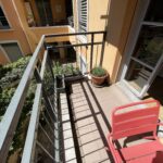 Sunny balcony overlooking a peaceful green garden at a host family home in Lyon