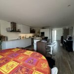 Spacious modern kitchen with breakfast bar and family dining table in a Lyon host family home.