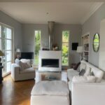 Bright and spacious family living room with fireplace, piano and garden views in Charbonnières-les-Bains near Lyon.
