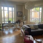 Bright living and dining room with large windows overlooking the Saône in central Lyon.