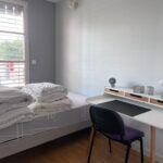 Furnished private bedroom with bed and desk for an international student in Lyon