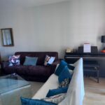 Comfortable family living room with sofas and piano in a Lyon homestay