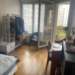 Bright student bedroom with desk, storage and balcony access in Lyon.
