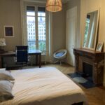 Bright and spacious student bedroom in central Lyon with a desk, parquet flooring, decorative fireplace and views over the Saône.