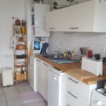 The shared kitchen is fully equipped for everyday use and benefits from direct access to the balcony.