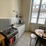 Equipped family kitchen with cooking facilities and dining area in Lyon.