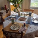 Dining table prepared for a shared meal in a welcoming Lyon host family home.
